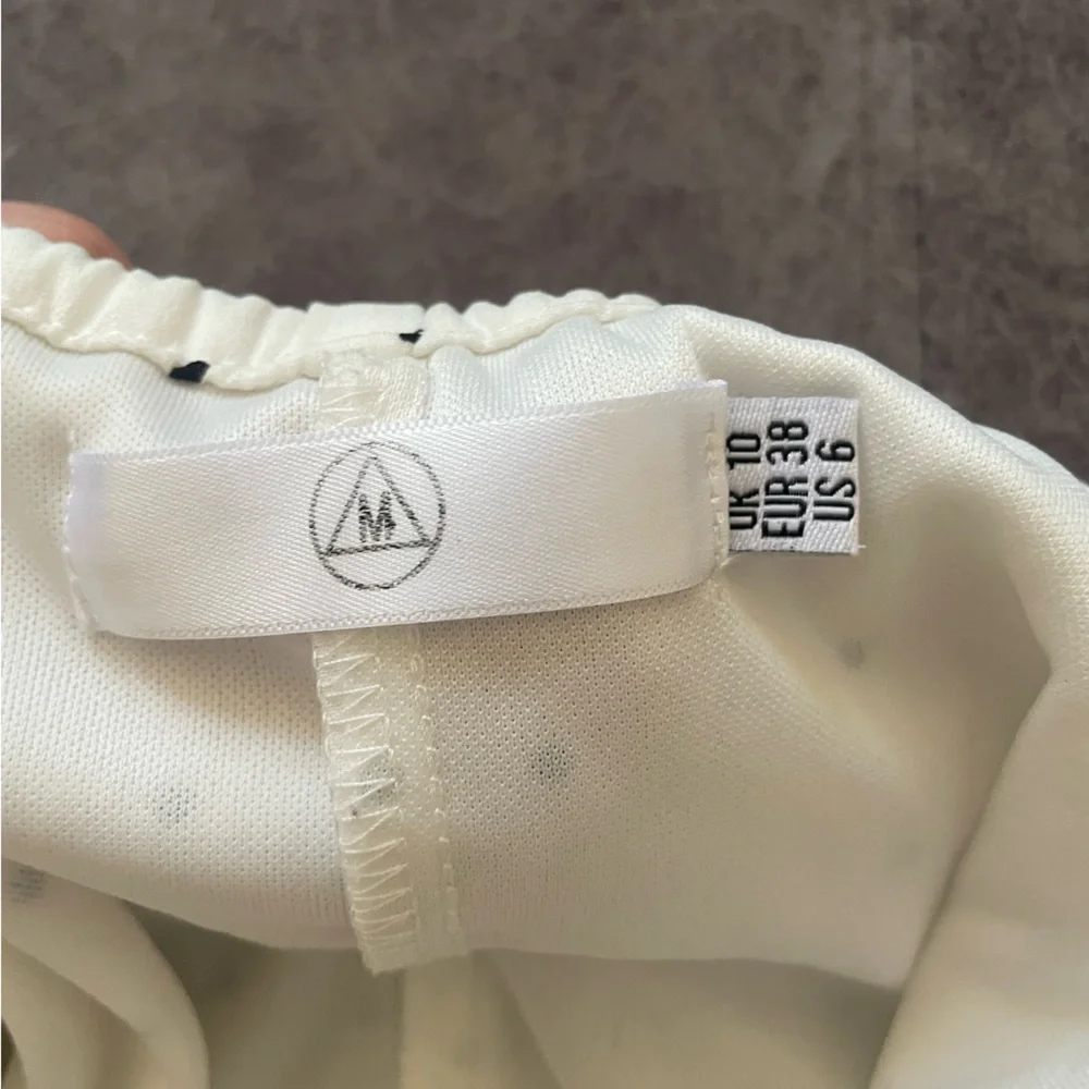 White with black polka dot romper. - Picture 3 of 3